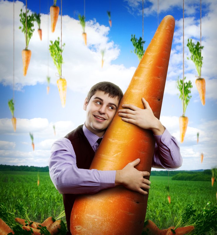 Huge carrot and businessman under blue sky